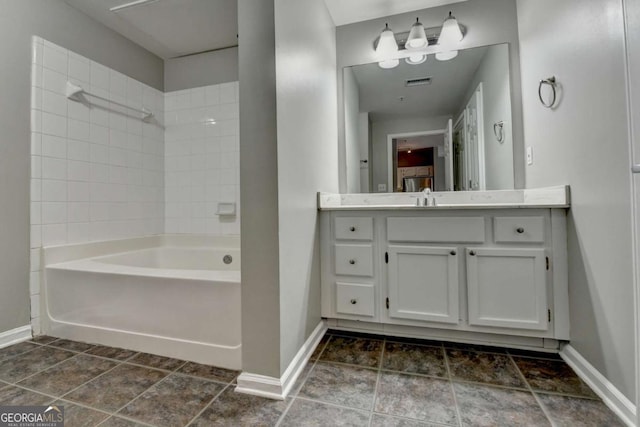 bathroom with tiled shower / bath and vanity