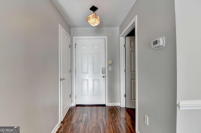 doorway with dark wood-type flooring