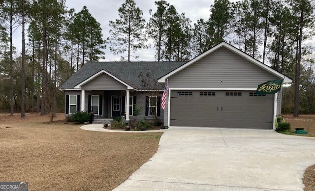 view of front of property with a porch and a garage