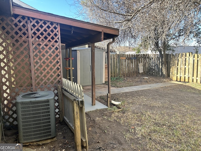 view of yard featuring central AC and a storage shed