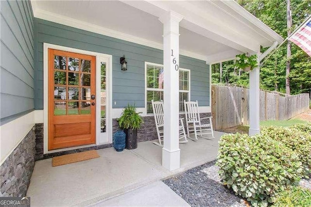 view of exterior entry with covered porch