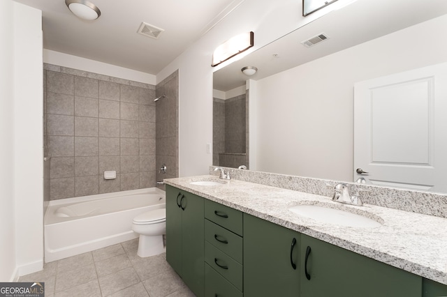 full bathroom with toilet, vanity, tile patterned floors, and tiled shower / bath