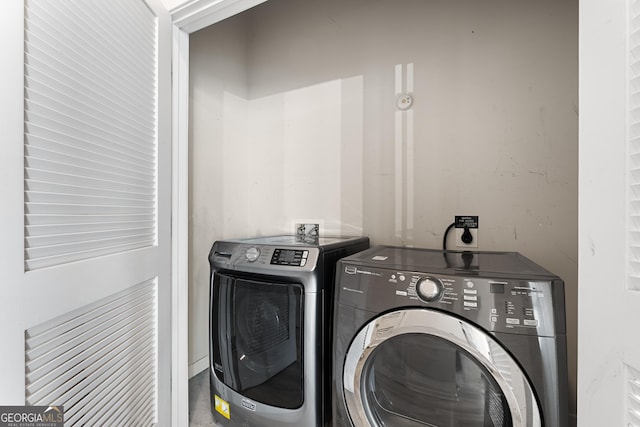 clothes washing area with separate washer and dryer