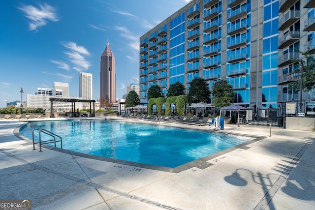 view of swimming pool featuring a patio area and a pergola