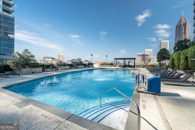 view of swimming pool featuring a patio and a pergola