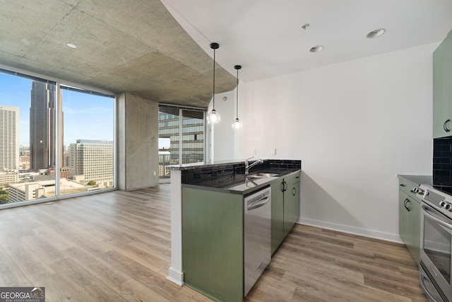 kitchen with stainless steel appliances, light wood-type flooring, kitchen peninsula, a wall of windows, and pendant lighting