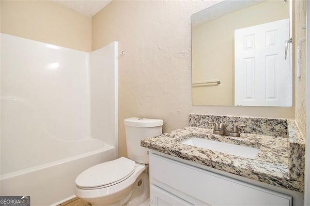 full bathroom with toilet, shower / bathing tub combination, and vanity