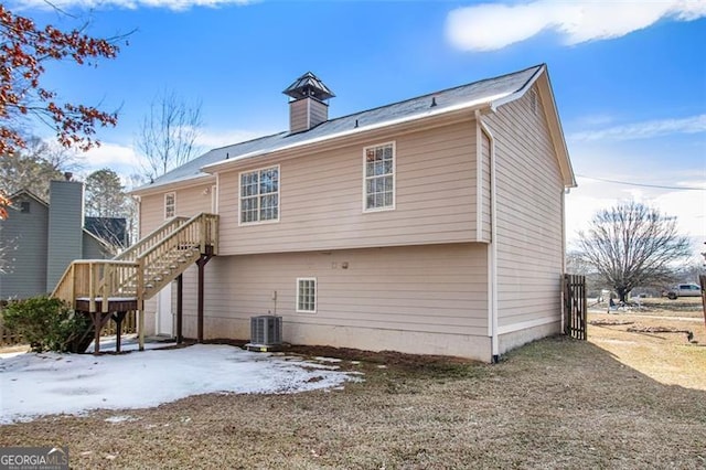 rear view of property with central AC unit