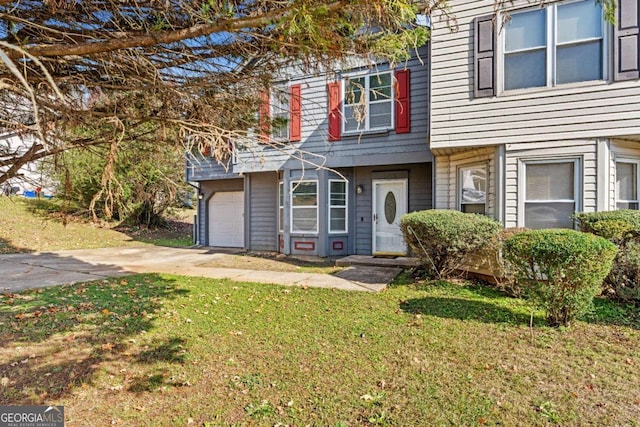 view of property featuring a front lawn