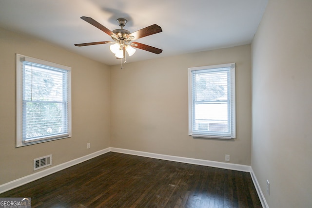 spare room featuring ceiling fan and dark wood-type flooring