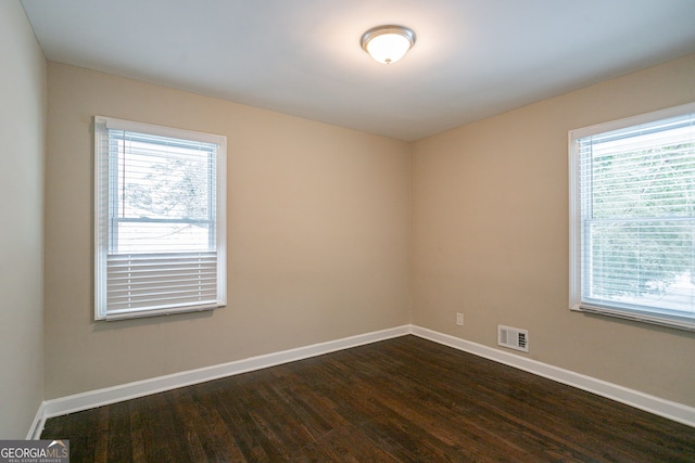 empty room featuring dark hardwood / wood-style floors