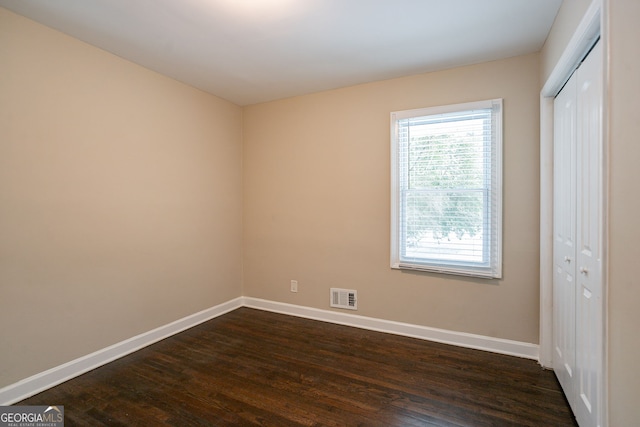 unfurnished room featuring dark hardwood / wood-style floors