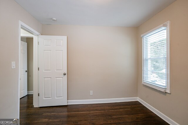 unfurnished room featuring dark hardwood / wood-style floors