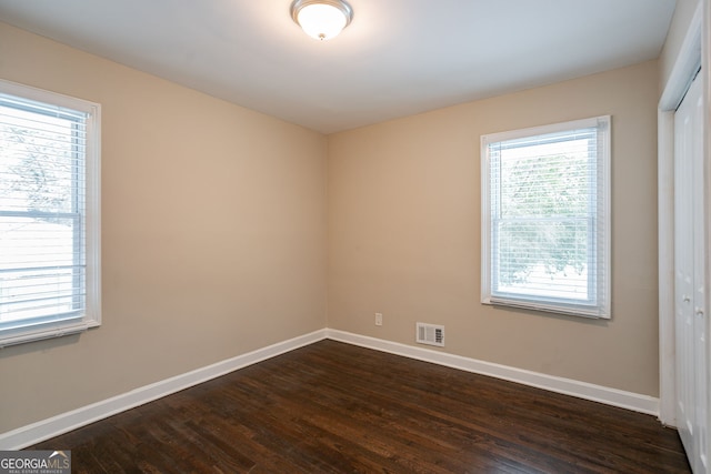 unfurnished room with dark hardwood / wood-style floors