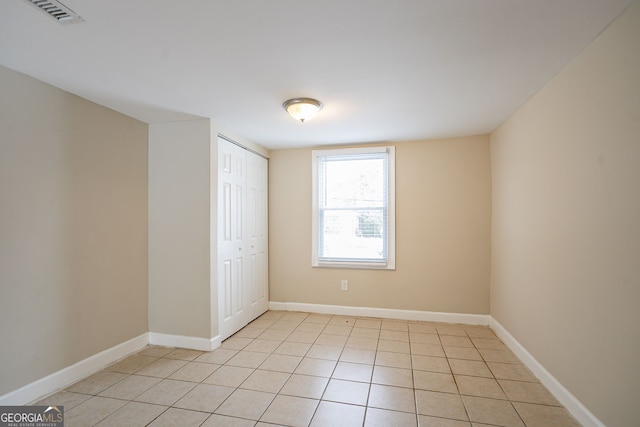 spare room featuring light tile patterned flooring