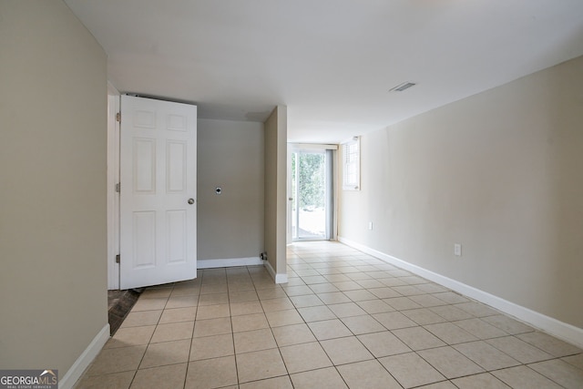 unfurnished room with light tile patterned flooring