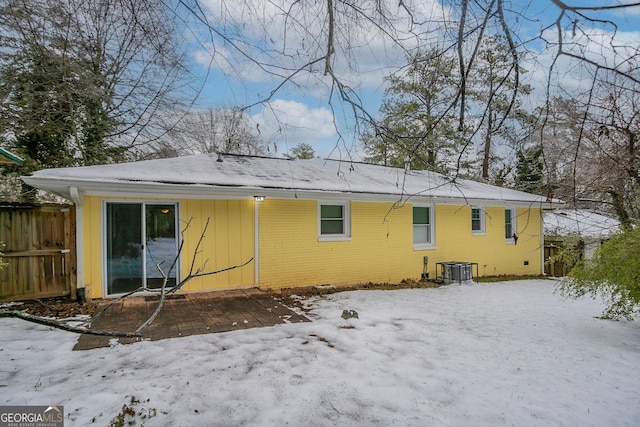 snow covered property featuring central air condition unit