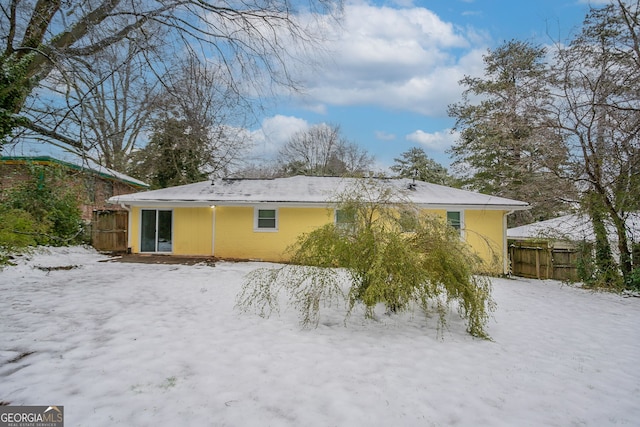 view of snow covered rear of property