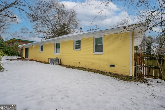 view of snow covered back of property