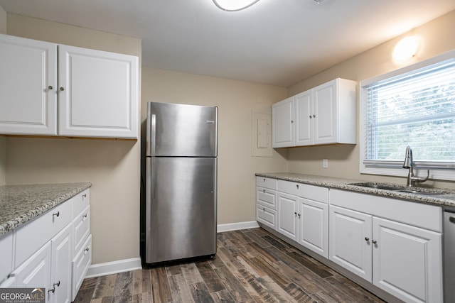 kitchen featuring sink, appliances with stainless steel finishes, white cabinets, light stone counters, and dark wood-type flooring