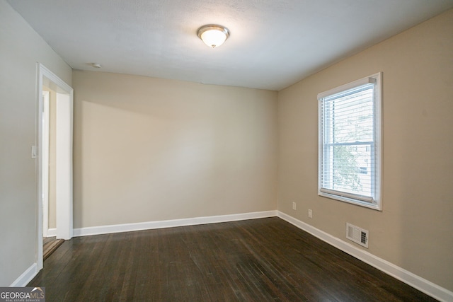 unfurnished room featuring dark hardwood / wood-style flooring