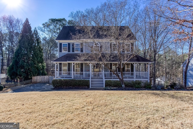 view of front of home with covered porch and a front lawn