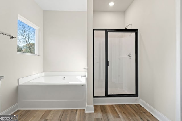 bathroom featuring hardwood / wood-style floors and shower with separate bathtub