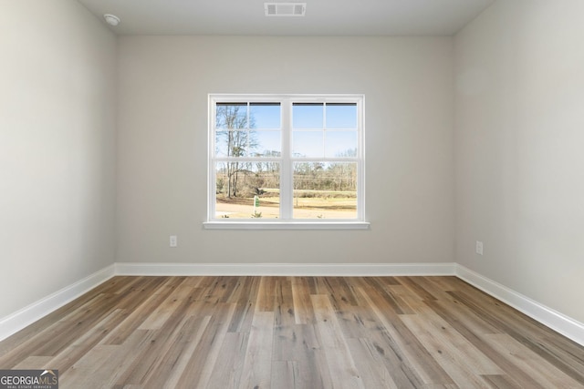 unfurnished room featuring light hardwood / wood-style flooring