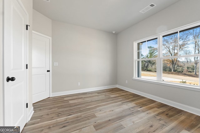 spare room featuring light hardwood / wood-style floors