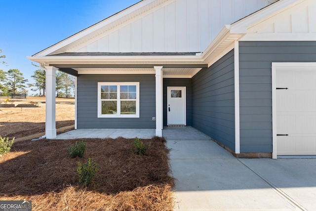 view of exterior entry with a porch