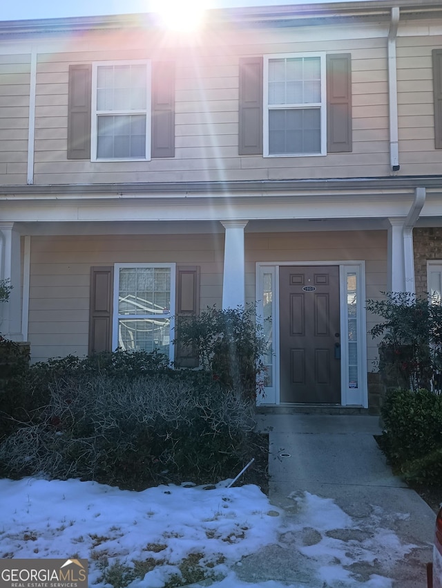 view of snow covered property entrance