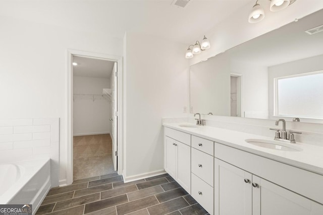 bathroom with vanity and a tub to relax in