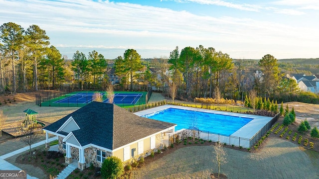 view of swimming pool featuring tennis court