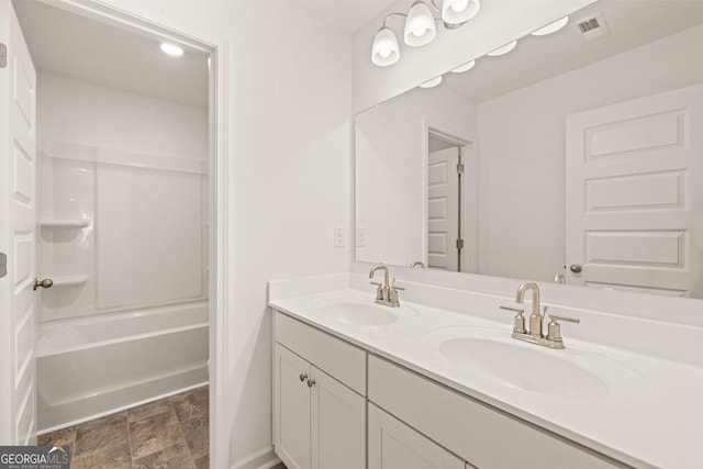 bathroom with vanity and shower / washtub combination