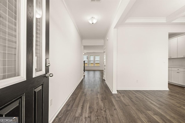 corridor with dark wood-type flooring and ornamental molding