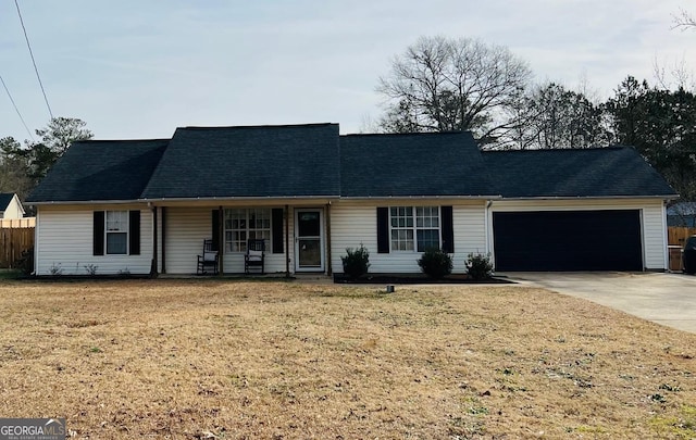 ranch-style house featuring a front yard, a garage, and a porch