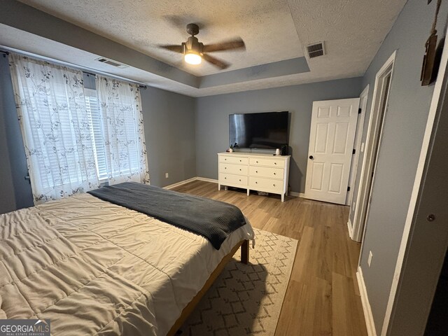 unfurnished bedroom featuring a textured ceiling, ceiling fan, and wood-type flooring