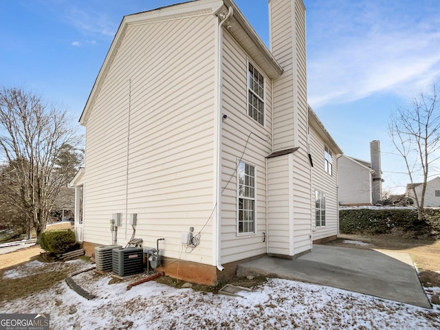 view of snowy exterior featuring a patio