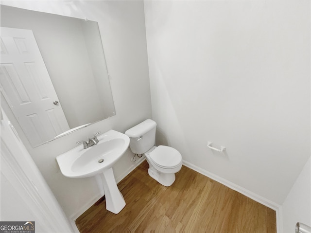 bathroom with hardwood / wood-style floors and toilet