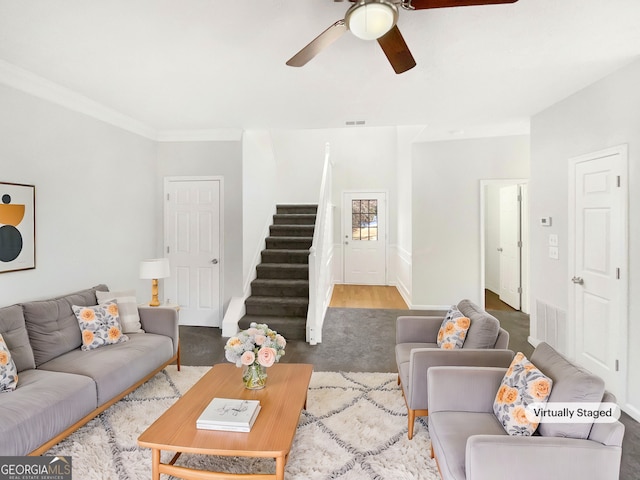 living room with ceiling fan and crown molding