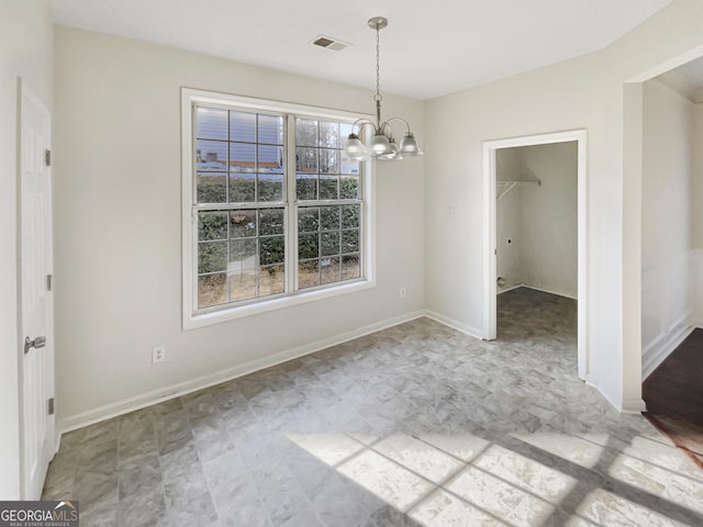 unfurnished dining area featuring a notable chandelier