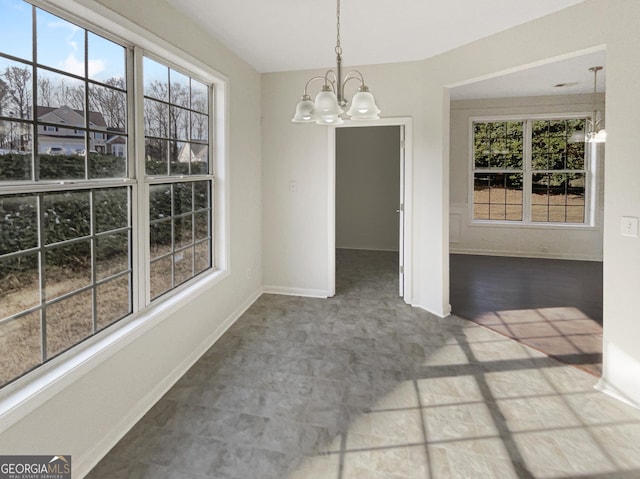 unfurnished dining area with an inviting chandelier