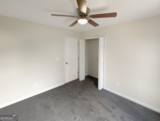 unfurnished bedroom with dark carpet, a closet, and ceiling fan