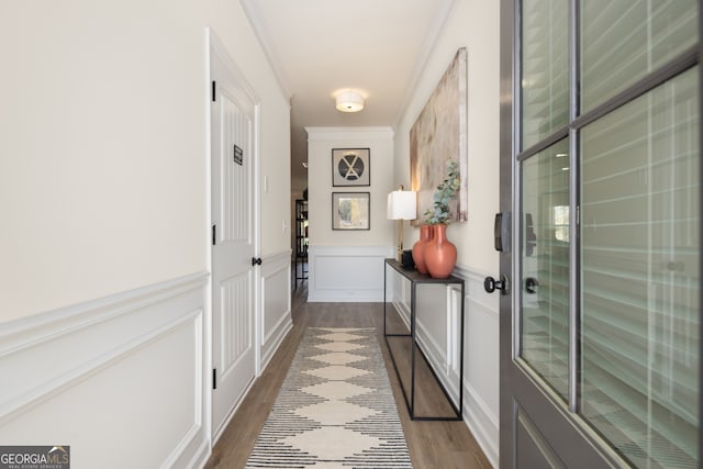 doorway to outside featuring hardwood / wood-style flooring and crown molding