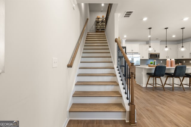 stairway featuring hardwood / wood-style floors