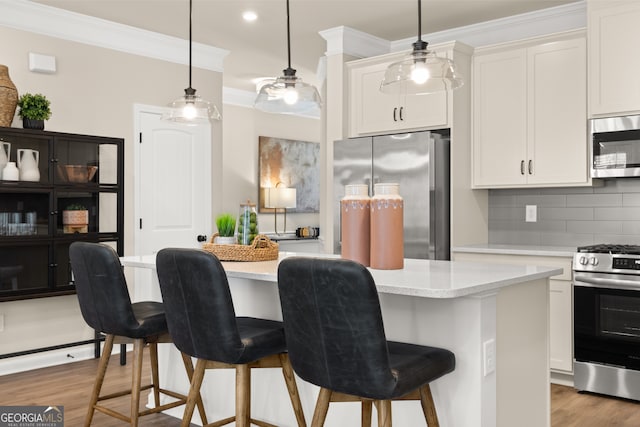 kitchen with stainless steel appliances, crown molding, a kitchen island, white cabinetry, and backsplash