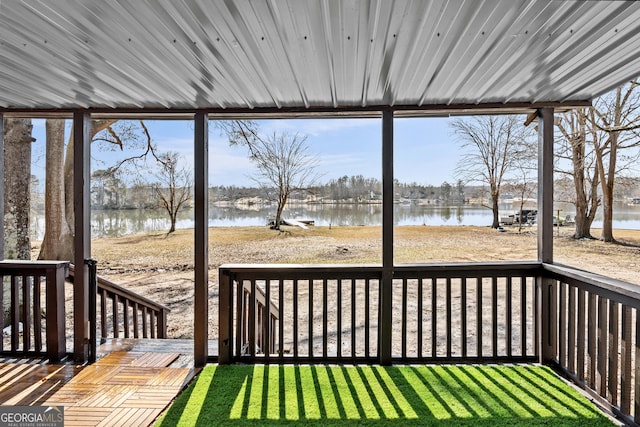 wooden terrace featuring a water view