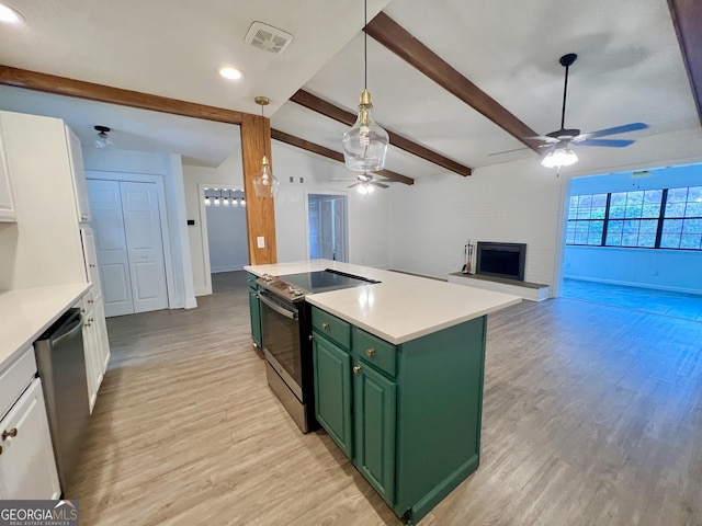 kitchen with stainless steel appliances, green cabinetry, white cabinetry, beamed ceiling, and a kitchen island