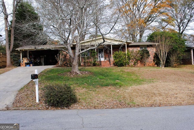 view of front of house with a front yard and a carport