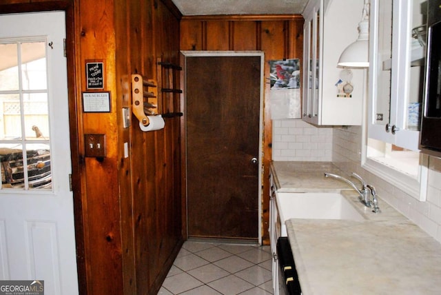 bathroom featuring sink, decorative backsplash, plenty of natural light, and tile patterned flooring